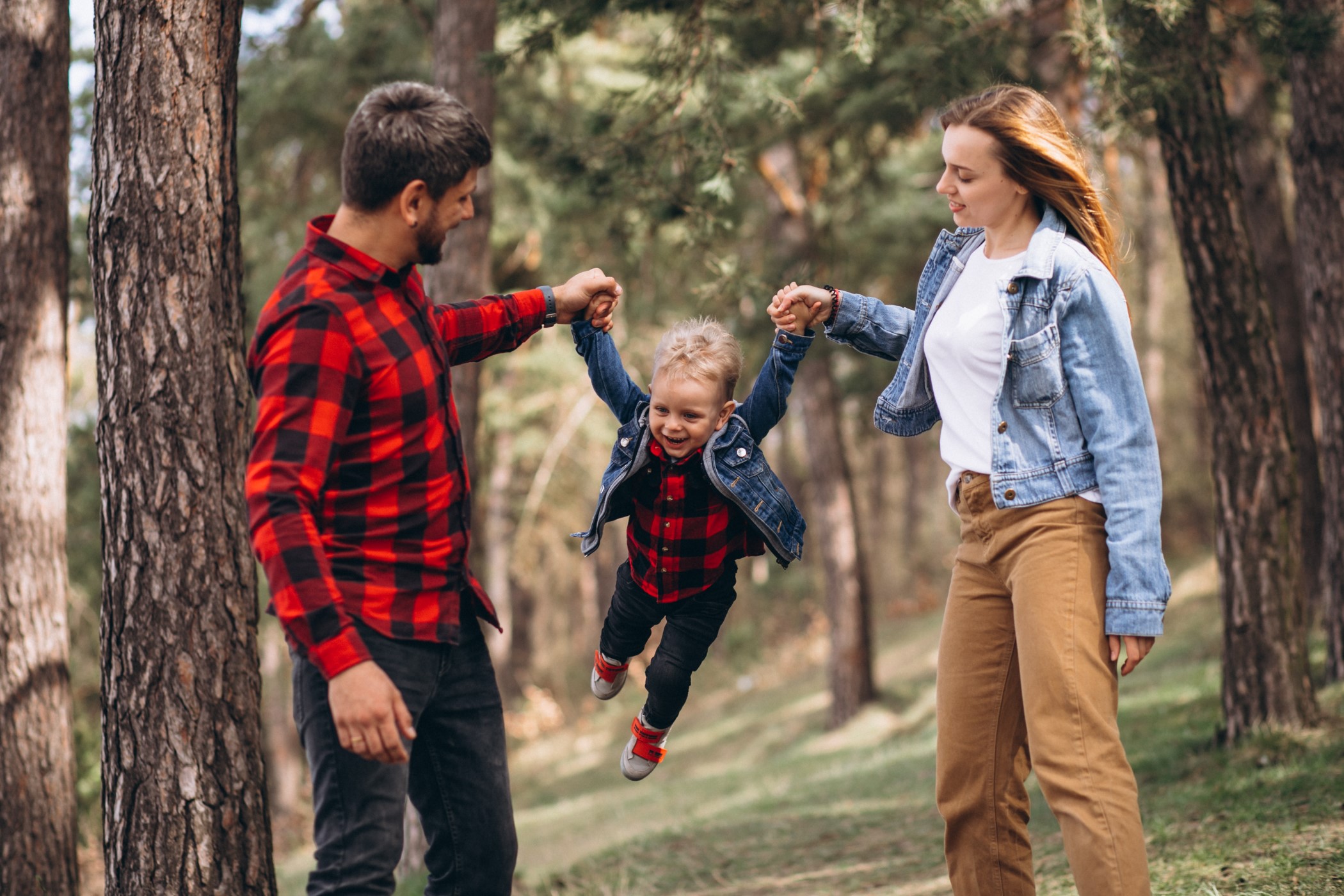 Family with little son together in their backyard rental property in flagstaff managed by Unlimited Real Estate